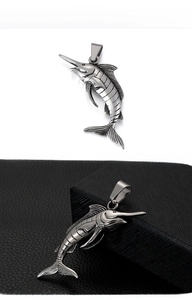 Detailed macro view of punk style stainless steel sailfish pendant with vintage silver finish