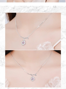 Detailed view of silver cherry blossom necklace featuring a central pink zircon stone