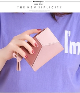 Detail of pink and brown patchwork leather wallet with cute bunny ear charm accessory