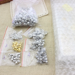 Flat brass abacus spacer beads and silver pendants in poly bags for DIY jewelry making