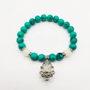 Detail of turquoise beads with silver lotus cage pendant and crystal spacers for yoga