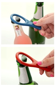 Tennis racket style plastic bottle opener set in blue and red shown opening soda bottles