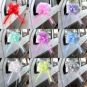 Macro display of nine colorful macaron gift bows installed on car side mirrors