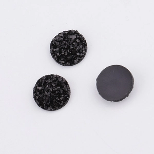 Macro detail of 10mm black resin druzy cabs with textured crystalline surface for DIY jewelry