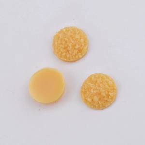 Detail shot of 10mm yellow resin cabochons showing textured surface and flat base back