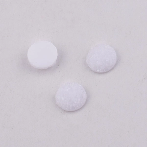 Detail of 10mm white starry resin druzy cabochons showing textured crystal surface