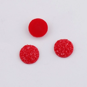 Macro detail of three 10mm red resin cabochons with sparkling druzy crystal texture for DIY