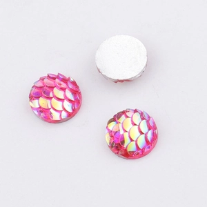Detail of 10mm round pink mermaid scale resin cabochons with iridescent AB finish