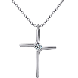 Macro shot of silver minimalist cross pendant with a brilliant center zircon on link chain