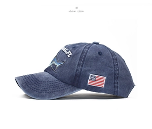 Detail view of navy washed cotton baseball cap with shark embroidery and US flag label