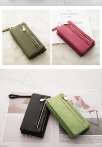 Detailed view of long PU leather wallets in green, pink, and black with wrist straps