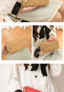 Close-up of vintage suede long wallet with dual zippers and golden hardware accents