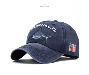 Detail view of navy blue washed cotton baseball cap with shark embroidery and US flag patch