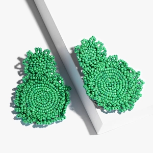 Handmade emerald green seed bead drop earrings in a stylish bohemian geometric design