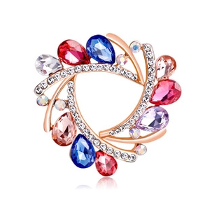 Detail of rose gold brooch with colorful teardrop crystals on white background