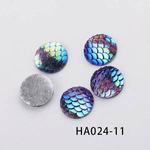 Close-up of 16mm round resin fish scale cabochons with iridescent gradient color