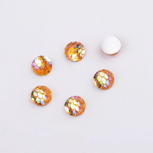 Macro shot of 8mm orange fish scale resin cabochons showing flat back for DIY jewelry