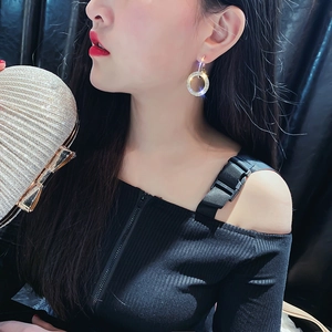 Sparkling silver-tone geometric hoop earrings with crystals worn by a female model