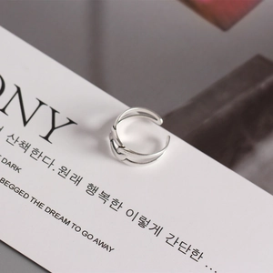 Close-up of minimalist layered S925 silver open ring with textured weaving design