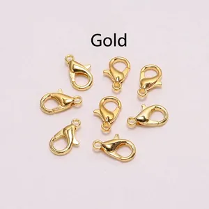 Close-up of eight gold alloy lobster clasps for DIY necklace and bracelet jewelry making