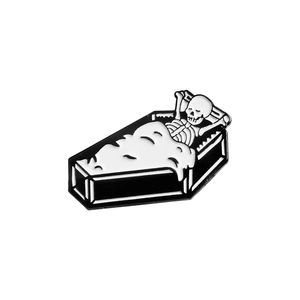 Halloween skeleton coffin enamel pin badge with black and white gothic aesthetic design
