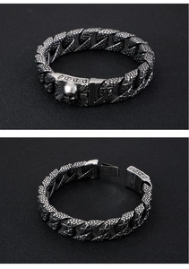 Detail of 316L stainless steel snake scale bracelet with a skull head clasp mechanism