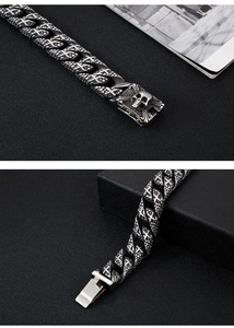 Detailed macro view of vintage silver skull charm and heavy stainless steel chain link