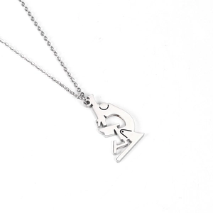 Macro shot of silver microscope pendant necklace with polished stainless steel texture