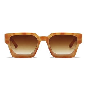 Detail view of tortoiseshell rectangular sunglasses with brown gradient lenses on white backdrop