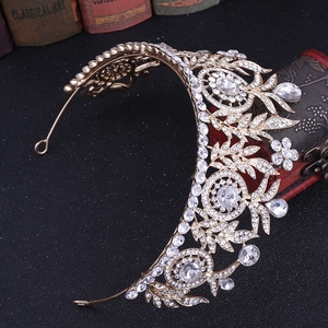 Close-up of golden bridal crown with sparkling crystals on a vintage book