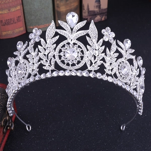 Elegant silver bridal crown with shimmering rhinestones on classical books background