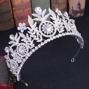 Detailed close-up of a silver bridal tiara with floral rhinestone patterns and crystals