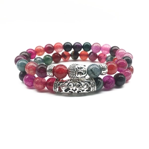 Detail of colorful crackle stone beads bracelet with a silver Buddha head charm