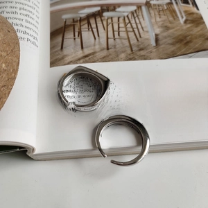 Close-up of minimalist adjustable 925 sterling silver rings with geometric triangle design