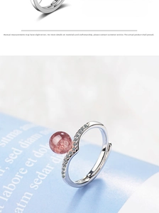 Detail of strawberry quartz ring with silver wave band and sparkling cubic zirconia