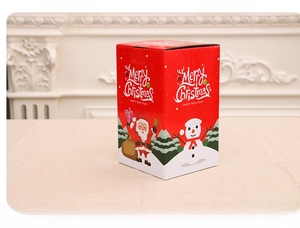 Detail of red Christmas music box with Merry Christmas text and pull-switch mechanism