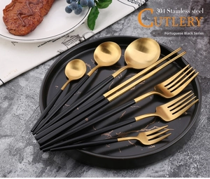 8-piece black and gold 304 stainless steel cutlery set displayed on a dinner plate