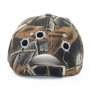 Detail of camouflage baseball cap back featuring realistic embroidered bullet hole designs