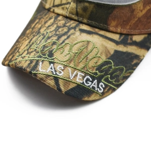Detail of Las Vegas embroidery on camouflage baseball cap brim with fine needlework