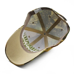 Detailed interior of camo baseball cap showing 100% acrylic tag and six-panel stitching