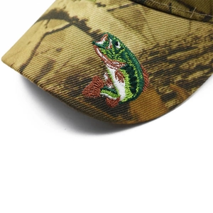 Macro view of detailed fish embroidery on camo brim of the baseball cap