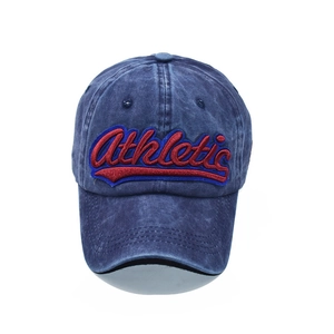 Macro shot of 3D athletic embroidery on navy blue washed cotton vintage baseball cap