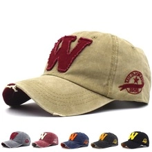Detail of multi-color distressed cotton baseball caps with W embroidery and vintage textures