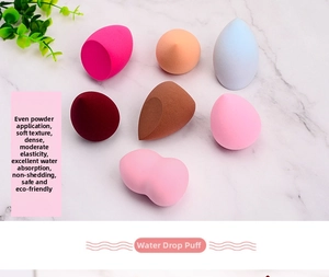 Macro shot of colorful multi-shaped makeup sponges on a marble background