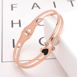 Rose gold heart bangle with black and white enamel charms and crystal accents