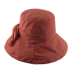 Foldable wide-brim sun hat for women in brick red with elegant side bow tie detail