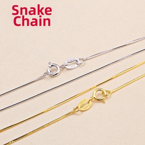 Macro shot of silver and gold snake chains with S925 and ITALY engraved hallmarks