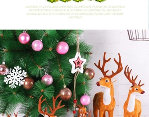 Detailed view of plush reindeer figurines and mixed Christmas ornaments against pine needles