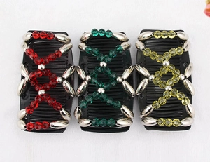 Detail of beaded magic hair combs with red green and yellow crystal patterns
