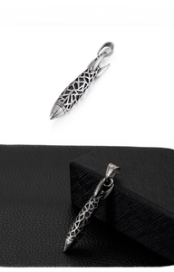 Macro detail of vintage hollow stainless steel rocket pendant with punk lattice design